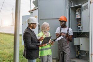 Multiracial people examining solar panels on station.jpg